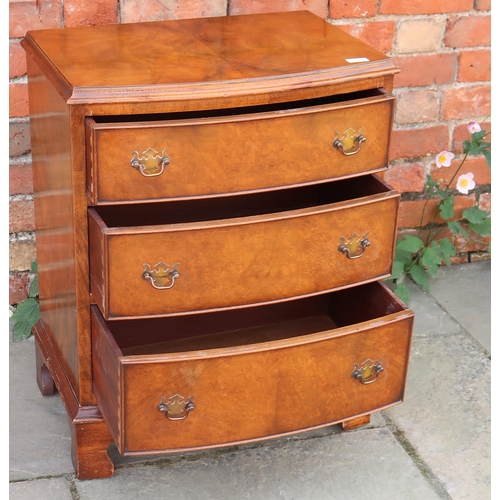 708 - A small walnut veneered bow fronted chest of three long graduated drawers raised on bracket supports... 