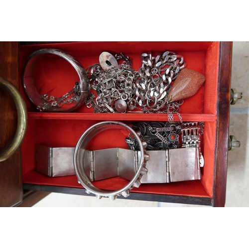 174 - A jewellery cabinet of eight drawers containing various silver and costume jewellery - items include... 