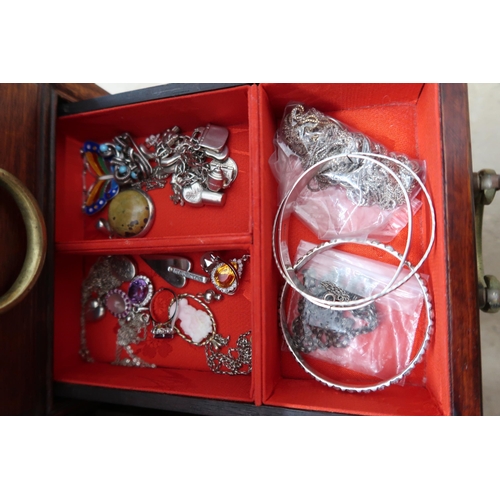 174 - A jewellery cabinet of eight drawers containing various silver and costume jewellery - items include... 