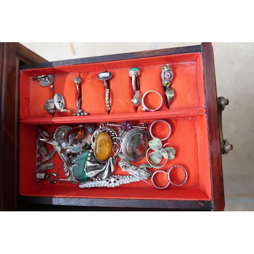 174 - A jewellery cabinet of eight drawers containing various silver and costume jewellery - items include... 