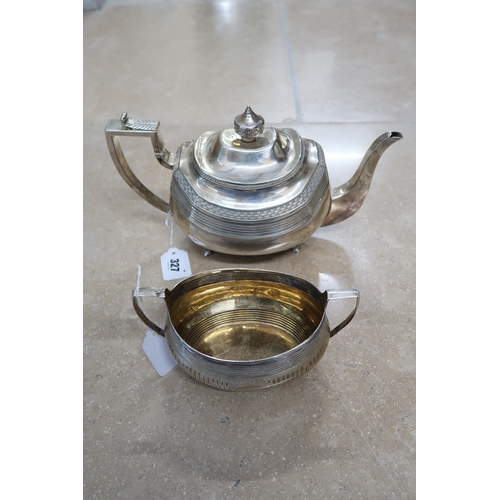 327 - A Silver H.M. Teapot London 1811 with weaved and ribbed decoration along with a matching sugar appro... 