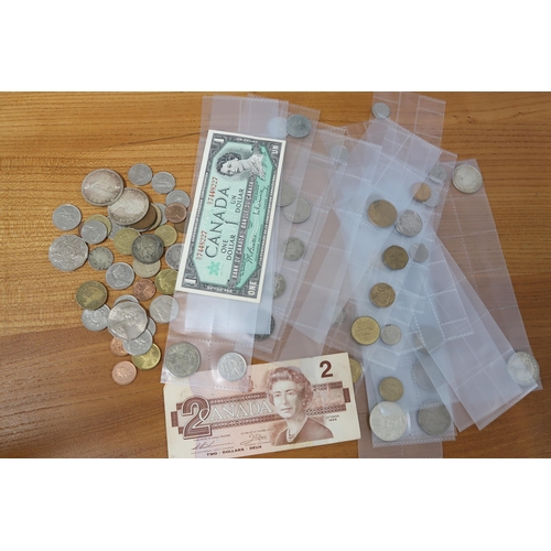 373 - A bag of Canadian and South African coinage including Canadian 1 & 2 dollar notes