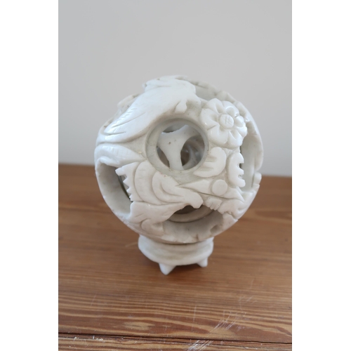 447 - A white jade six layer puzzle ball, 12cm in diameter, carved with bird, flowers and spray, in good c... 