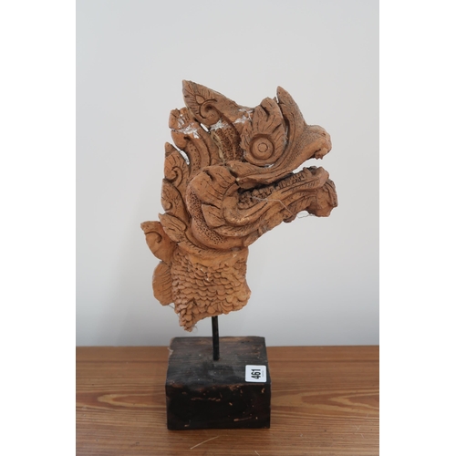 461 - An unusual Oriental carved Dragons Head, with wooden lining and terracotta overlay on stand 37cm hig... 