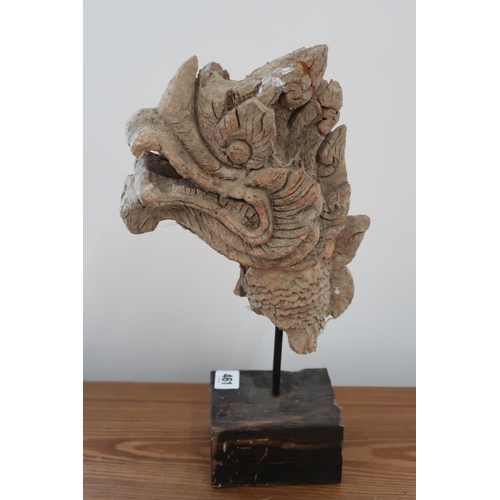 461 - An unusual Oriental carved Dragons Head, with wooden lining and terracotta overlay on stand 37cm hig... 