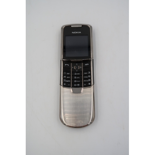 522 - A Nokia 8800 slide special edition silver stainless steel body with docking station - in good condit... 