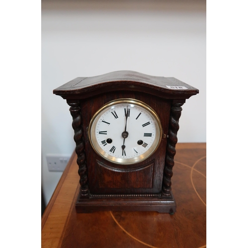 618 - A 20th century oak cased mantle clock with white enamelled dial with Roman numerals to chapter ring ... 