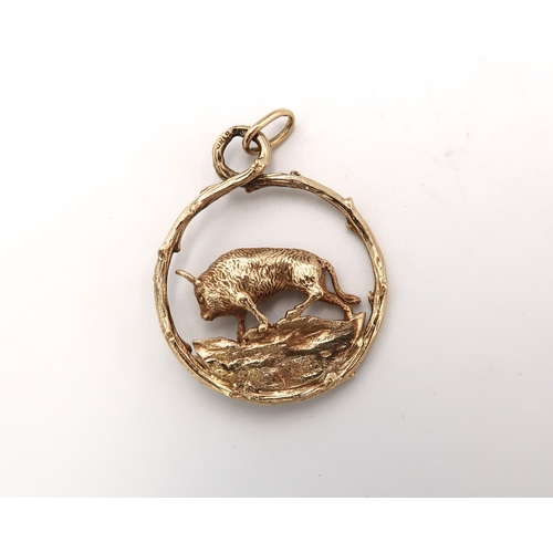  A 9ct hallmarked yellow gold pendant of circular form with bull to centre, approx 11.2 grams, clean ... 