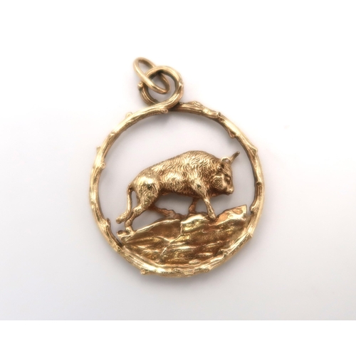  A 9ct hallmarked yellow gold pendant of circular form with bull to centre, approx 11.2 grams, clean ... 