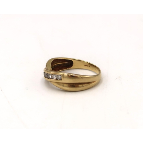  An 18ct gold brilliant cut diamond seven stone crossover band ring. Size S 1/2. Weight 4.91 grams. S... 