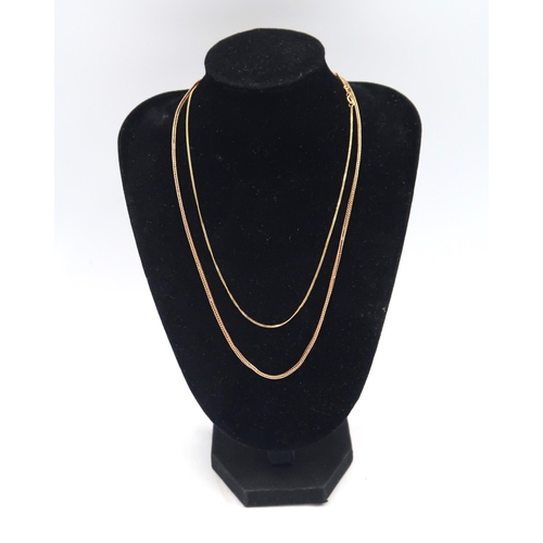  A 9ct yellow gold marked chain, 42cm long and another shorter, 5.6g total weight.