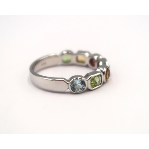 105 - A 9ct white gold multi stone ring consisting of peridots, citrine, garnet, amethyst and aquamarine -... 