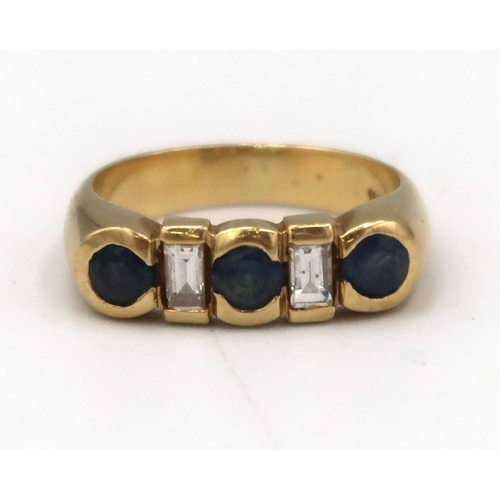 11 - A circular sapphire and baguette diamond dress ring. Size K. Weight 5.25 grams. Stamped 18K.