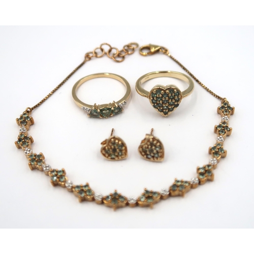 128 - Four pieces of 9ct gold Alexandrite jewellery. To include a panel bracelet. Weight 5.56 grams. A hea... 