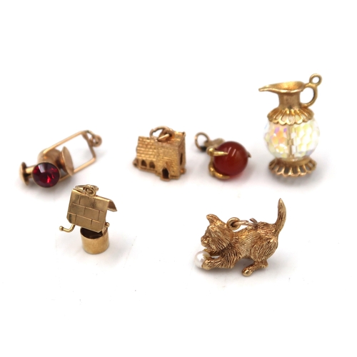 14 - An assortment of six charms. Tested as or with marks indicating 9ct gold. Weight 19.73 grams