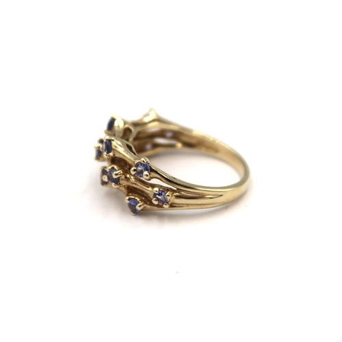 144 - A 9ct yellow gold three row tanzanite ring - head size approx 20mm x 8mm - ring size approx K