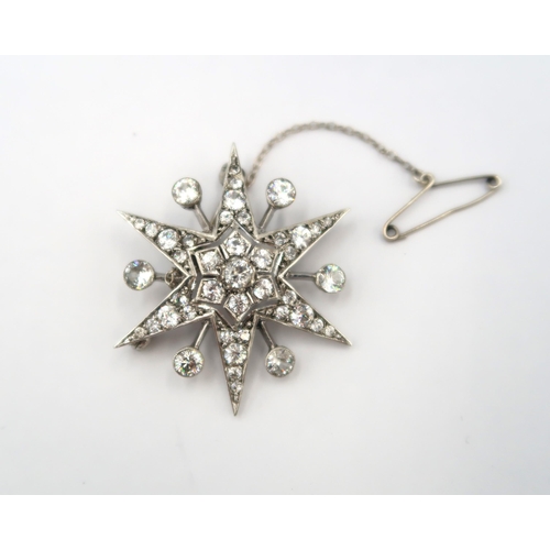 154 - A large Victorian silver zircon star burst brooch - head size approx 37mm x 37mm