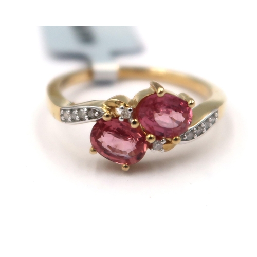 169 - A 9ct gold oval Padparadscha sapphire and single cut diamond crossover ring. Size M. Weight 2.17 gra... 