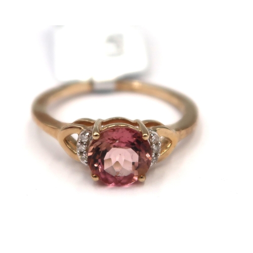 179 - A 9ct gold circular pink tourmaline and single cut diamond ring. Size O. Weight 2.17 grams