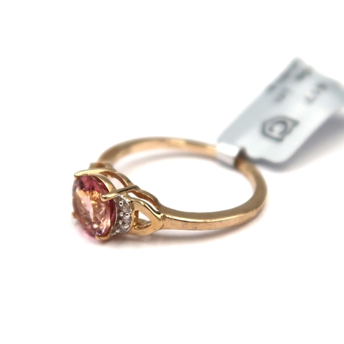 179 - A 9ct gold circular pink tourmaline and single cut diamond ring. Size O. Weight 2.17 grams