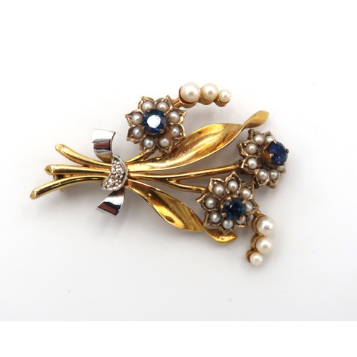 195 - A vintage 9ct gold, pearl, diamond and sapphire floral spray brooch, 6.4g.