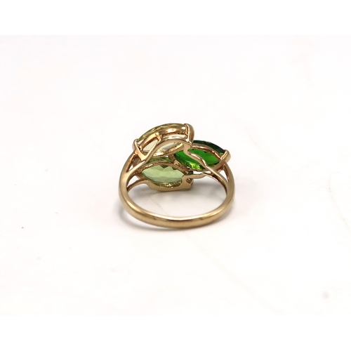 206 - A 9k gold marked dress ring, with citrine, peridot, and diopside to the shoulder, size K, 2.7g.