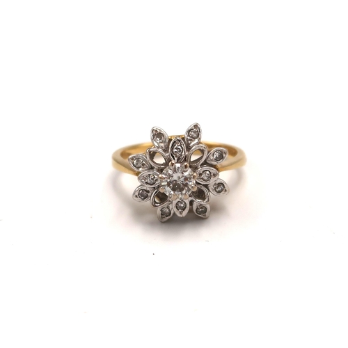 215 - An 18ct gold and diamond cluster ring with flower head design, with illusion set central, round cut,... 