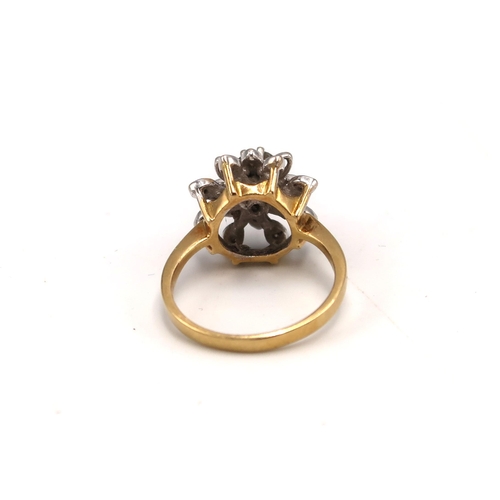 215 - An 18ct gold and diamond cluster ring with flower head design, with illusion set central, round cut,... 