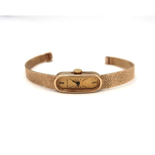 260 - A Ladies 9ct H.M. yellow gold cased wristwatch on a 9ct H.M. bracelet strap, Roman Numerals at 12, 6... 