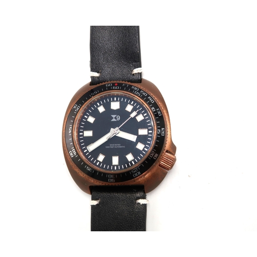 290 - A TC9 Turtle divers watch in brass case with black leather strap, black dial with baton markers, 4.1... 