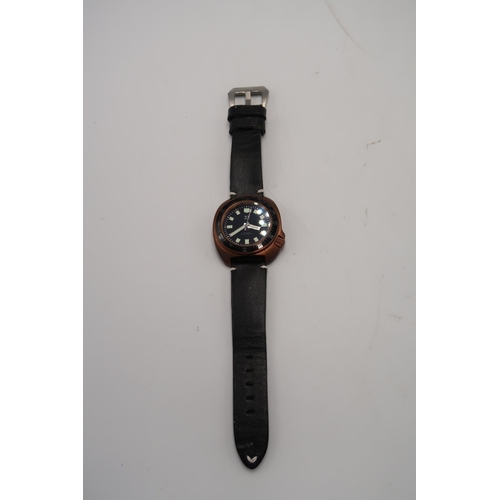 290 - A TC9 Turtle divers watch in brass case with black leather strap, black dial with baton markers, 4.1... 