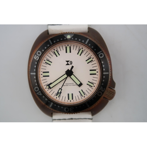 292 - A TC9 Turtle divers watch in brass case with white leather strap, white dial with baton markers, 4.1... 