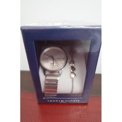 303 - A Tommy Hilfiger gentleman's wristwatch, the pink dial with baton markers, boxed as new.