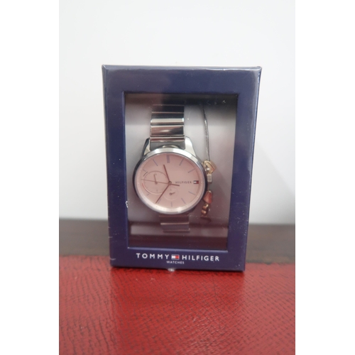 304 - A Tommy Hilfiger gentleman's wristwatch, the pink dial with baton markers, boxed as new.