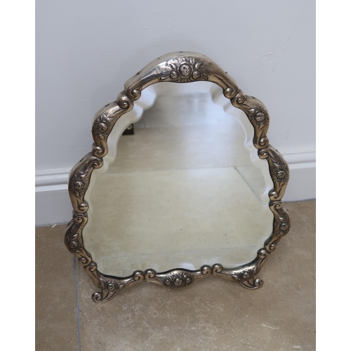 331 - A Continental silver cartouche shaped mirror, the frame decorated with floral sprays, 50cm high x 42... 