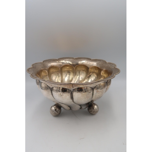 333 - A pair of .800 Continental silver, lobbed bowls with planished finish, beaded rims and standing on t... 