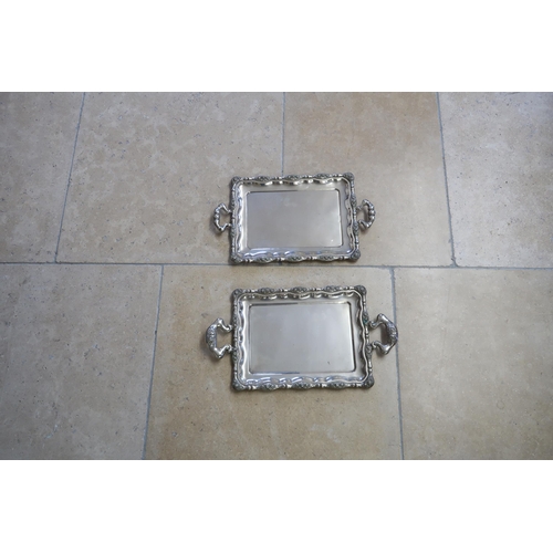 335 - Two Austrian white metal twin handled trays decorated with floral sprays to boarder