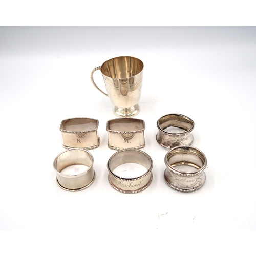 338 - Six hallmarked silver napkin rings, varying years and design along with a small silver hallmarked ta... 