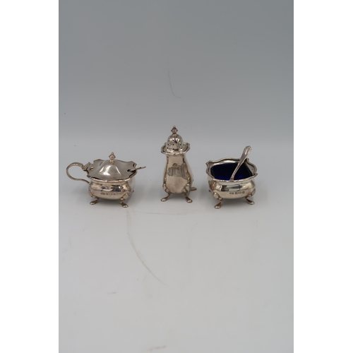 345 - A silver condiment set, complete with blue glass liners, with original box.