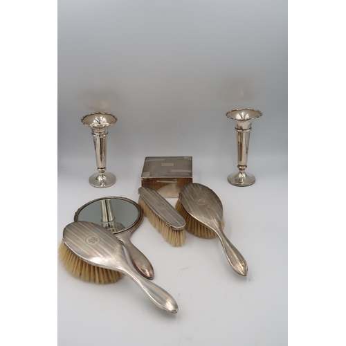 347 - Silver H.M. items including a cigarette box, trumpet vases and a dressing set of hand mirror, hair b... 