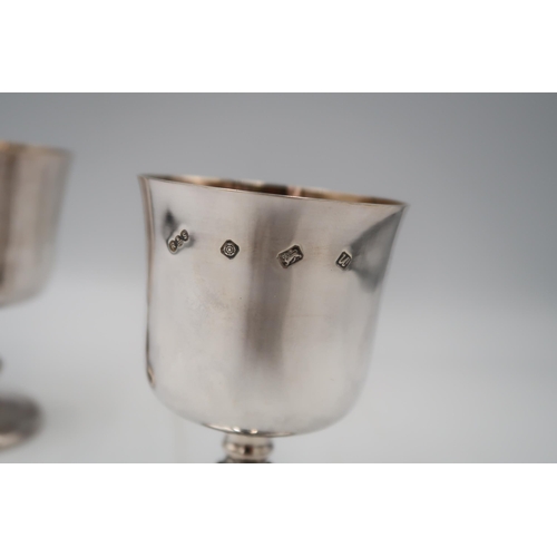 349 - A pair of late 20th century silver goblets of simple form, with Celtic detail to the knopped stems, ... 