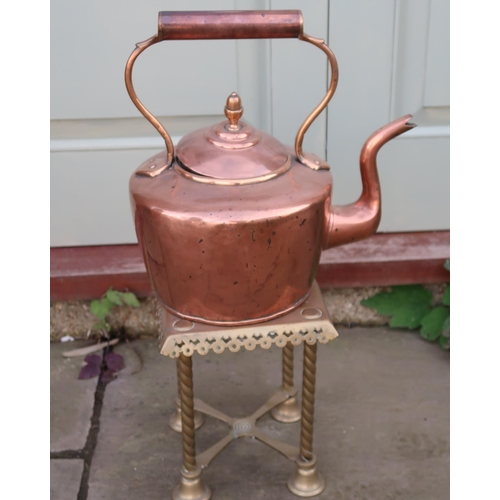 430 - A large copper kettle, 35cm high to top of handle, and a tall pierced brass trivet or stand.