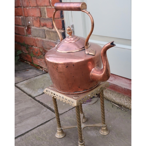 430 - A large copper kettle, 35cm high to top of handle, and a tall pierced brass trivet or stand.