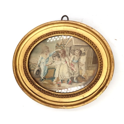 446 - A pair of framed oval Regency silk embroideries, scene depicting children playing.