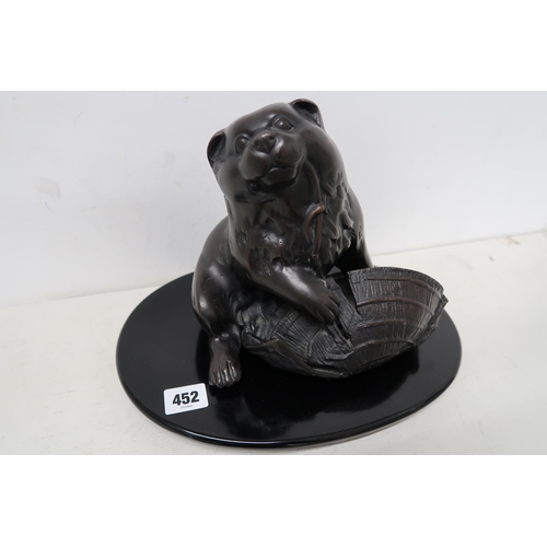 452 - A Japanese bronze sculpture of a Panda chewing a hat on docket - approx 24cm High x 32cm Wide