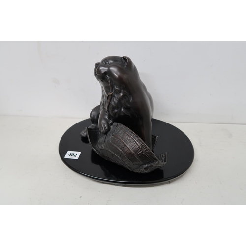 452 - A Japanese bronze sculpture of a Panda chewing a hat on docket - approx 24cm High x 32cm Wide