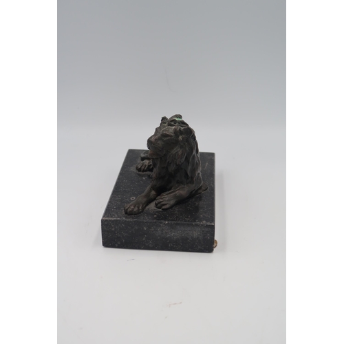 483 - A Bronze of a recumbent Lion set on marble base.