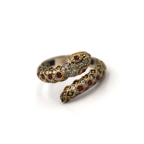 58 - A crossover snake ring set with CZ and ruby, possibly synthetic. Size T. Stamped 925. Weight 3.92 gr... 