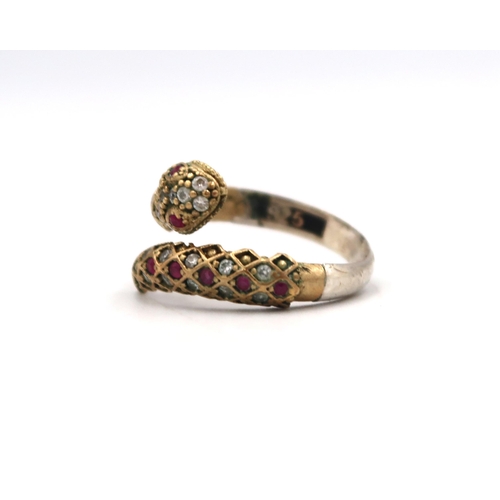 58 - A crossover snake ring set with CZ and ruby, possibly synthetic. Size T. Stamped 925. Weight 3.92 gr... 