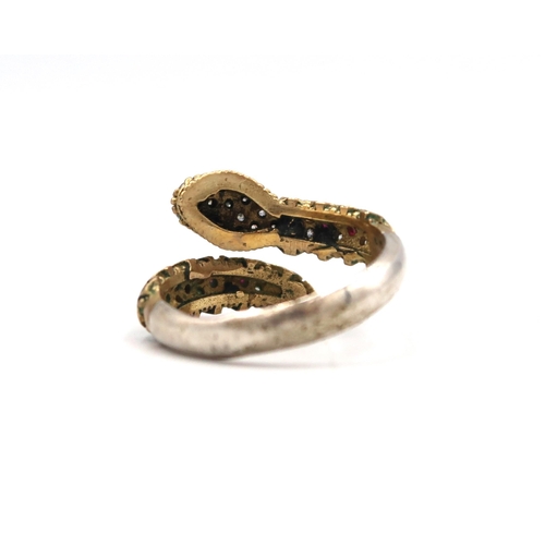 58 - A crossover snake ring set with CZ and ruby, possibly synthetic. Size T. Stamped 925. Weight 3.92 gr... 